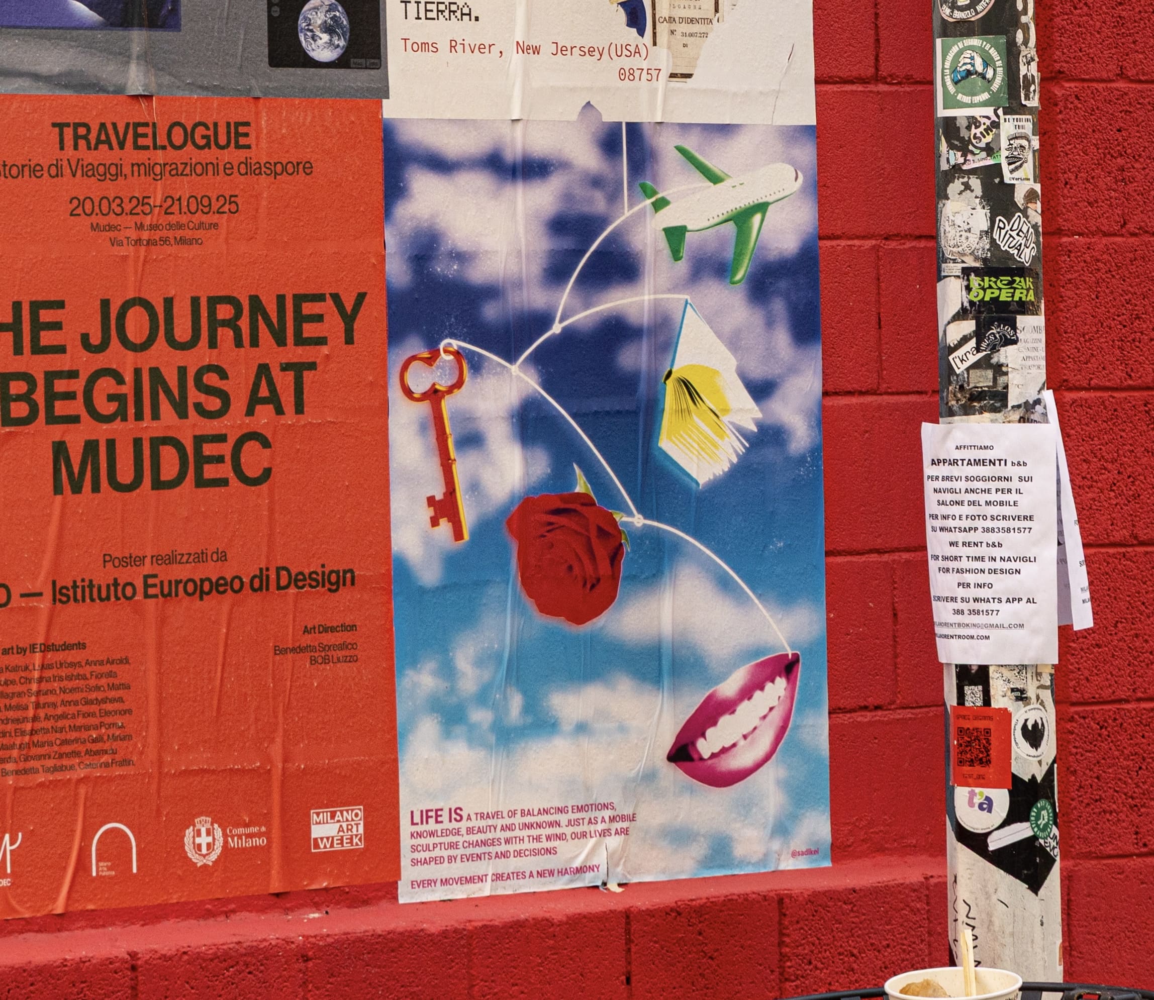 Person holding MUDEC campaign print in a street mockup
